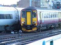 156506 approaches Glasgow Central and is dwarfed by the passing Pendolino.<br><br>[Graham Morgan 05/01/2007]