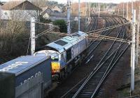 Stobart Rail 66411 with the Tesco containers bound for Grangemouth passing Carstairs South Junction on 5 January. <br><br>[John Furnevel /01/2007]