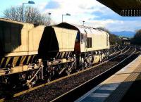 Sunstruck coal empties head south through Dalmeny station on their way back to Hunterston Import Terminal on 10 January 2006.<br><br>[John Furnevel /01/2006]