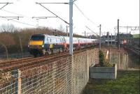 A GNER Glasgow Central - Kings Cross train bypassing Newton station on the WCML heading for Motherwell on 5 January 2007. The EMU in the background is a Newton terminating service laying over in the refuge siding pending its scheduled return to Glasgow. On the far right is the line to Hamilton and Larkhall.<br><br>[John Furnevel 05/01/2007]