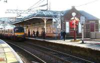 A westbound service stops at Coatbridge Sunnyside in January 2007 alongside the 1888 station building.<br><br>[John Furnevel /01/2007]