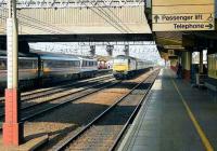 A 47 on a straight run south through Crewe station as a class 90 makes a stop with a northbound service. August 1990. <br><br>[John McIntyre 25/08/1990]