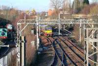 A Balloch train heads west at Sunnyside Junction, shortly after leaving Coatbridge Sunnyside station in January 2007. The line coming in bottom centre is from Whifflet South Junction and the partially lifted line heading off centre right under the bridge once ran to Gunnie Yard. On the left of the picture are some of the exhibits at the Summerlee Heritage Museum and on the horizon stand the cranes of Coatbridge Freightliner Terminal.<br><br>[John Furnevel /01/2007]