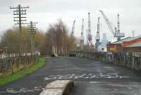 Looking east to Whitinch Riverside. Telegraph poles remain for some of the length of the line. The cranes of the Govan shipyard can be seen to the right.<br><br>[Ewan Crawford 09/01/2006]