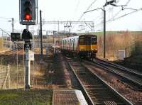 A service for Glasgow Central, having run back from the reversing siding, crosses over at Newton to start its return journey in January 2007.<br><br>[John Furnevel 05/01/2007]