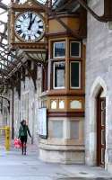 The bay window of Perth station's down centre signal box, and the famous clock are ignored by an intending passenger anxiously looking at the timetable in January 2007.<br><br>[Brian Forbes 14/01/2007]