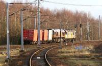 A class 92 takes a freight consisting of 4 containers and a dead class 66 locomotive south away from Carstairs on 5 January 2007.<br><br>[John Furnevel 05/01/2007]