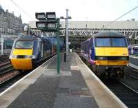 The GNER 0950 Aberdeen - Kings Cross HST pulls out of Waverley on 4 February 2007 passing  90019, one of the EWS class 90s decked out in First ScotRail livery for use on the Caledonian Sleepers.<br><br>[John Furnevel 04/02/2007]