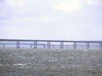 The <I>High Girders</I> of the rail bridge are seen looking west between the supports of the road bridge. Pictured from Broughty Ferry.<br><br>[Brian Forbes /04/2006]