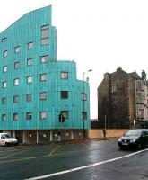 The wall linking Edinburgh's old and new versions of tenement housing (!) spans the gap once occupied by the entrance and booking office of Abbeyhill station. View south on 12 February 2007 across London Road.<br><br>[John Furnevel 12/02/2007]