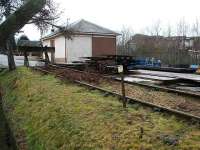 The old goods yard at Loanhead in February 2007 looking southwest, with the station house visible beyond the goods shed. The buildings in the right background were part of the long closed Ramsay Colliery. Photographed through a gap in the fence of what is now a council depot.<br><br>[John Furnevel 12/02/2007]