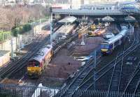 Waverley update 14 February. 66115 at the front end of a spoil train in platform 17 as a Glasgow shuttle finds a path into 14.<br><br>[John Furnevel 14/02/2007]