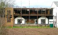 Auchtermuchty in March 2007 - some 57 years after closure [see image 14020]. The buildings have changed hands, with the Sterling brand replacing that of Rippin Structures and the former offices now used for general storage. The station clock and bench have gone.<br><br>[John Furnevel 06/03/2007]