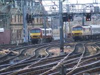 90035 sitting at Bridge Street waiting to collect the late running Caledonain Sleeper which passes by powered by 90020 <I>Collingwood</I>.<br><br>[Graham Morgan 19/03/2006]