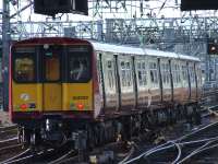 314202 departs Glasgow Central. This was the final Class 314 unit in SPT orange and black, and is now back in service after an overhaul and re-paint.<br><br>[Graham Morgan 19/03/2006]