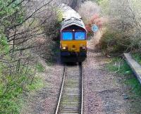 Having just left the ECML at Piershill Junction 66184 turns north onto the Abbeyhill loop and towards Powderhall Depot with the returning <I>Binliner</I> containers on 19 March. The platform used for the Meadowbank Stadium Commonwealth Games stands on the right.<br><br>[John Furnevel 19/03/2007]