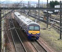 A North Berwick - Waverley 322 service runs past the fuelling roads at Craigentinny in March 2007 with the main depot in the background.<br><br>[John Furnevel 21/03/2007]