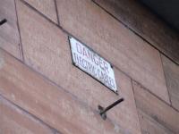 Sign warning of the overhead cables still in place on the facade of the building.<br><br>[Colin Harkins 27/03/2007]