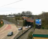 A North Berwick train bound for Waverley speeds past Portobello Junction on the ECML in March 2007 as an EWS class 66 with a trainload of imported coal climbs the gradient from the South Leith branch towards the main line. Just to the lower right is the original course of the Edinburgh and Dalkeith Railway from Niddrie West, now crossed by both main line and branch. [See image 53420]<br><br>[John Furnevel 22/03/2007]