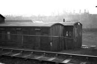 Tales of old Ferryhill no 43. Grounded old coaching stock - used in steam depots for everything from the general store to the tea bothy to the bike shed. Craiginches prison stands on the horizon on a grey day in 1973.     <br><br>[John McIntyre /01/1973]