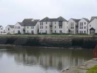 The housing covers a large goods yard. Centre of pier was where tramp steamers tied up. There was a wagon <i>tip-up</i> which when the door was opened the coal would drop into the hold. Timber was unloaded from Scandinavia on the north pier (left out of shot).<br><br>[Brian Forbes /03/2007]