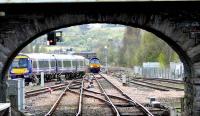 The 1138 service from Glasgow takes the Dundee line at St Leonards and passes 66405 with the Aberdeen Intermodal (via the up line) which is waiting for the junction to clear.<br><br>[Brian Forbes 10/04/2007]