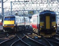 91002 <i>Durham Cathedral</i> departing Glasgow Central, with 156433 Kilmarnock Edition pulling into the station.<br><br>[Graham Morgan 24/03/2007]