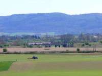 Rolling along. Edinburgh train heads for Bridge of Earn across the Earn Viaduct with a tractor rolling a field.<br><br>[Brian Forbes 17/04/2007]