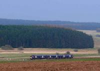 Approaching Blackford from the south, a Turbostar bound for Perth passing a fir forest.<br><br>[Brian Forbes /04/2007]