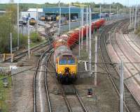 Virgin 57308 <I>Tin Tin</I> heads south from Kingmoor yard towards Carlisle on 18 April 2007. The train is passing the DRS Depot with a trainload of timber for Chirk. <br><br>[John Furnevel 18/04/2007]