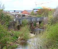 Looking north from the former Viaduct Yard, Carlisle on 18 April 2007. Spanning the river is what remains of the Caldew Viaduct, which formerly carried traffic on the joint goods lines, avoiding Citadel station. [See image 3549]<br><br>[John Furnevel 18/04/2007]