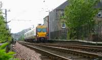 A westbound train heading for Wemyss Bay passing the houses of Lilybank Road shortly after leaving Port Glasgow station on 29 April 2007. The train is about to run through Wemyss Bay Junction.<br><br>[John Furnevel 29/04/2007]