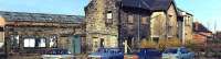 Panorama showing Dunfermline Upper station exterior shortly before demolition in 1990.  Note the BR posters still clinging doggedly to the notice boards some 20 years after closure to passengers.<br><br>[Craig Seath /08/1989]