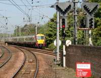 Looking north from the Largs side at Kilwinning station on 3 May as a train from Glasgow Central approaches the Ayr platforms. <br><br>[John Furnevel 3/05/2007]