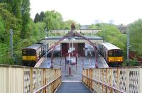 Passing trains for Glasgow Central and Neilston respectively meet at Muirend station on a Sunday morning in May 2007. View is north east towards Cathcart.   <br><br>[John Furnevel 06/05/2007]