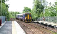 A train for East Kilbride pulls into Giffnock on 6 May 2007 under the recently repainted footbridge.<br><br>[John Furnevel 06/05/2007]