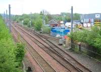 The line through the yellow gate gives access to the PW depot now operated by STRC (formerly Jarvis) to the east of Shettleston station and seen here on Sunday 13 May 2007. The line turning south beyond the yard entrance is the stub of the former NB route to Hamilton, now  built over around 100 yards south of this point.  <br><br>[John Furnevel 13/05/2007]