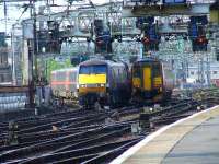 A Class 156 departs while passed by a Class 91 pulling into Glasgow Central to form a service for Kings Cross<br><br>[Graham Morgan 28/04/2007]