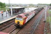 8.30am on a wet Thursday at Carstairs. 57316 <I>Fab1</I> held in the down loop on a freight awaiting a passing movement off the Edinburgh line. The passengers are off the 05.10 Manchester Piccadilly - Glasgow Central awaiting the <I>branch connection</I> to Waverley. [See image 15040]<br><br>[John Furnevel 17/05/2007]