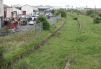 Remains at Ardrossan North in May 2007 with the Arran Ferry berthed in the background. The line continued on to Montgomerie Pier with a link to the G&SW Winton Pier branch turning off to the left just beyond the end of the platforms. A large Shell refinery, together with associated sidings, once occupied much of the land to the right of the picture. Ardrossan North lost its passenger service in 1932. The Shell refinery closed in the 1980s. [See image 23867]<br><br>[John Furnevel 17/05/2007]