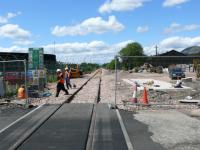 Looking west from the rubber surfaced level crossing. Workers are running cables from the conduit on left of track to under the base of a signal relay cabinet.<br><br>[Brian Forbes 21/05/2007]
