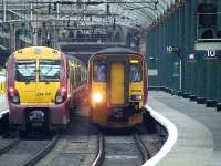 156503 passes 334011 as it departs for Edinburgh Waverley.<br><br>[Graham Morgan 12/05/2007]