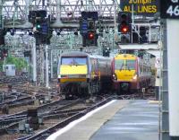 Departing GNER service for Kings Cross passes a Class 334 making its way into Glasgow Central.<br><br>[Graham Morgan 10/05/2007]