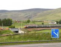 Glasgow - Euston Pendolino runs past a PW squad alongside the M74 near Crawford on 22 May 2007.<br><br>[John Furnevel 22/05/2007]