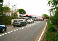 Don't even think about it! A southbound Pendolino speeds south over Cleghorn level crossing near Lanark on 24 May 2007.<br><br>[John Furnevel 24/05/2007]