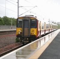 A wet Sunday morning 20 May 2007 at Cardonald, as a non-stop westbound empty stock movement runs through the station at speed.<br><br>[John Furnevel 20/05/2007]