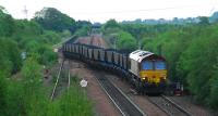 Squeak! Scrunch! Coming out of the loops at Dunfermline Townhill. The wagons (with natty blue trim) making more noise than the locomotive. The former route to Dunfermline Upper and Stirling is to the left.<br><br>[Ewan Crawford 02/06/2007]