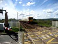 Helensburgh train approaching Ardmore East LC on 28 May. The original Ardmore box was on the far side of the crossing on the left. <br><br>[John McIntyre 28/05/2007]