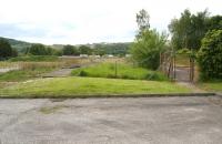 View west from Station Road, Dalbeattie, between the truncated remains of the infilled platforms in May 2007. Part of what was the up (Dumfries bound) platform now lies behind the fence on the right [see image 15412] with the site of the old goods yard over to the left. <br><br>[John Furnevel 29/05/2007]