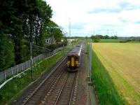 Carlisle - Glasgow (via Dumfries) service passing the site of Rockcliffe station in May 2007. The station house can be seen through the trees while in the right background stand the lighting towers of Kingmoor yard. <br><br>[John McIntyre /05/2007]